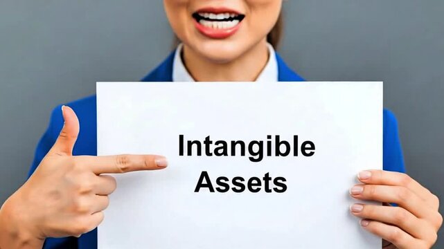 Video, close-up, employee's hand with document text &lsquo;Intangible assets&rsquo;, financial information, wealth, company, brands, patents, trademarks, knowledge, goodwill, licenses 