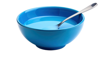 A blue bowl containing a liquid substance with a spoon inside viewed from above