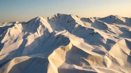Majestic snow-capped mountain range at sunrise with golden sunlight hitting peaks, vast winter landscape with blue shadows, cold arctic wilderness nature scene, high altitude alpine heights