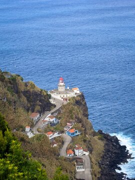 Picturesque lighthouse (Farol do Arnel) on the east coast of Sao Miguel island. Azores.