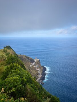 Picturesque lighthouse (Farol do Arnel) on the east coast of Sao Miguel island. Azores.
