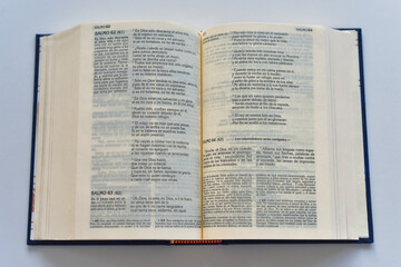 Obraz premium Open Spanish Bible Showing Psalm 63 on White Background 