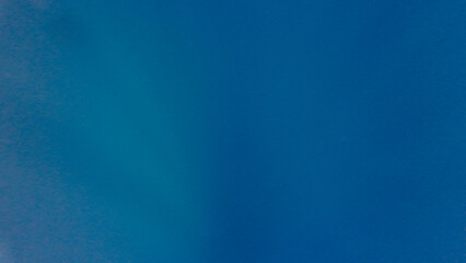 Blue abstract background. Abstract underwater view of deep blue ocean water with smooth gradient texture. Minimal seascape background showing calm abyss and natural color transition.