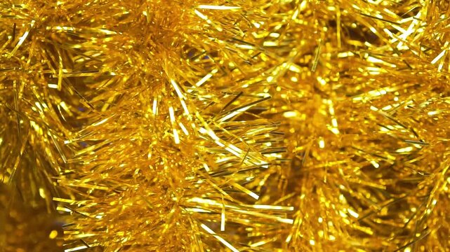 Shimmering gold tinsel garland, Christmas decor. Celebration backdrop, party decorations