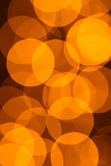 Bright bokeh circles created by out-of-focus lantern lights glow against a dark background. Warm, soft light shapes suggest a festive nighttime atmosphere, abstract illumination, and a celebratory moo © Lilly