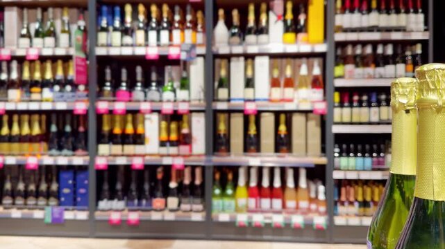 defocused alcohol (wine, champagne, liquor, whiskey) on store shelves