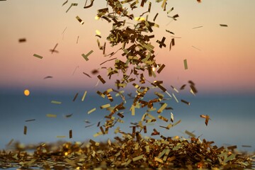 A shimmering golden confetti cascading through the air