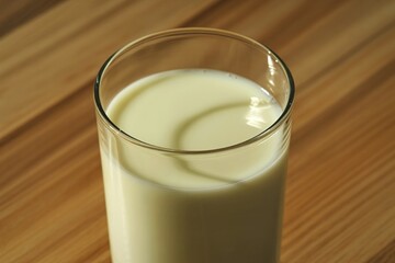 a tall glass filled with creamy white milk