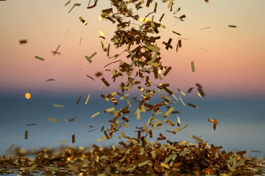 A shimmering golden confetti cascading through the air