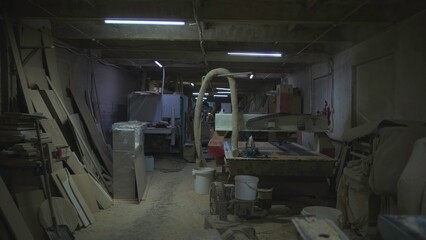 Workshop Cluttered With Equipment And Dust, Crowded Timber Shop Filled With Machinery And Shadows. Media