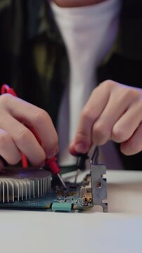 Close Up. Engineer soldering microcircuit. Unknown male hands with a tool repairs a home electronic appliance and screwdriwer on the table at hom. Slow motion.
