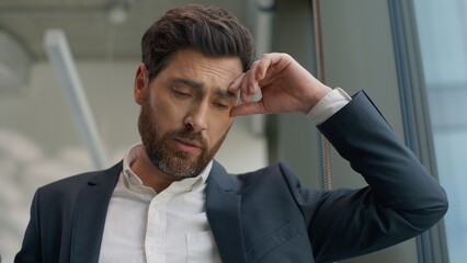 Portrait sad upset stressed fatigued tired business man in office leaning window feeling stressful with work problem job fired unemployment businessman male working failure frustrated bankruptcy