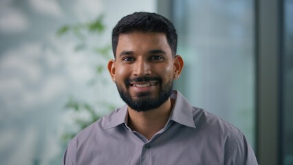Close up Indian Muslim businessman Arabian business man in office portrait looking at camera smiling happy carefree male employer entrepreneur company worker corporate manager satisfied job success