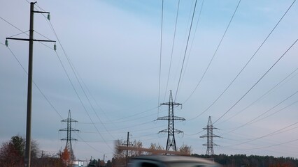 Driving past high voltage power lines and electrical pylons. Media