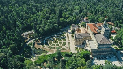 Bussaco Palace in Luso Portugal with green garden red rooftops old building castle royal resudence...