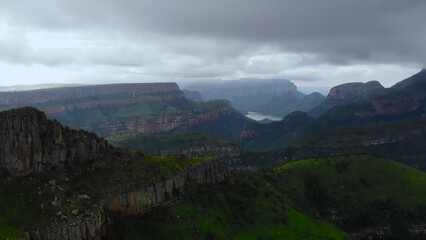 Fototapeta premium layered terraces and ridges, misty conditions conceal stratified ridges and fissured mountain terrain