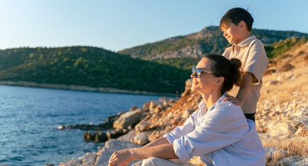Smiling Mom with Child Enjoying Beach View