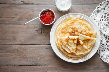 Homemade thin crepes with red caviar