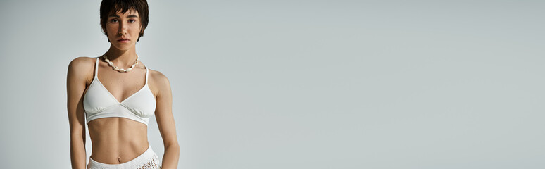 Stylish young woman showcasing confidence and beauty in a modern artistic setting