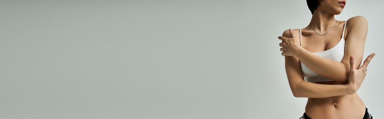 Stylish young woman exuding confidence in a minimalist setting with a soft background