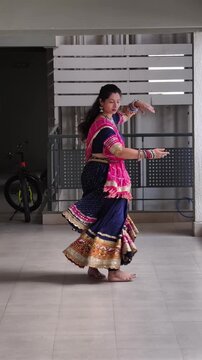 Indian woman performing Garba dance in chaniya choli with full flair, wearing oxidized jewellery and bandhani dupatta, celebrating vibrant folk culture, tradition, and Navratri festival energy.