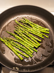Bunch of asparagus saut&eacute;ed on the pan.