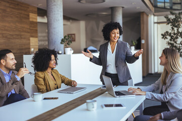 Confident Female Leader Presents During A Diverse Business Meeting In Modern Office