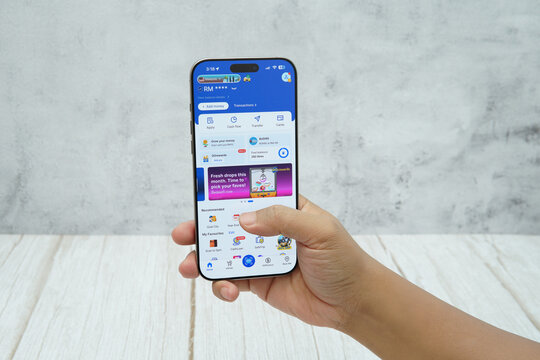 Rawang, Selangor, Malaysia - &lrm;January 21, 2026 - Hand holding smartphone displaying Touch &rsquo;n Go eWallet mobile application interface. Editorial context of digital payment, cashless transaction.
