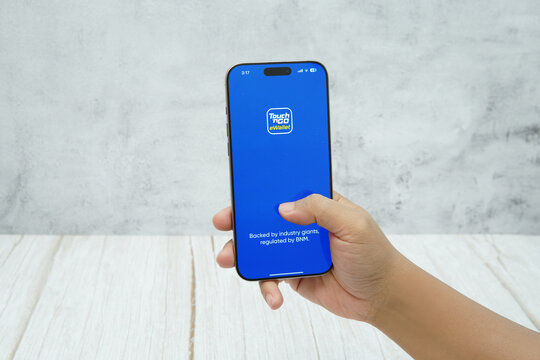 Rawang, Selangor, Malaysia - &lrm;January 21, 2026 - Hand holding smartphone displaying Touch &rsquo;n Go eWallet application logo on screen. Editorial context of digital payment, cashless transaction.