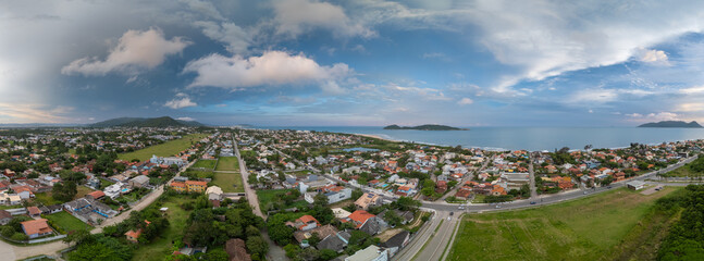 Aerial panorama of the Atlantic ocean coast and calm green neighborhood near the city of Florianopolis in Brazil © Dudarev Mikhail