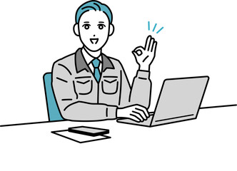 デスクで作業をしている作業着の男性のイラスト