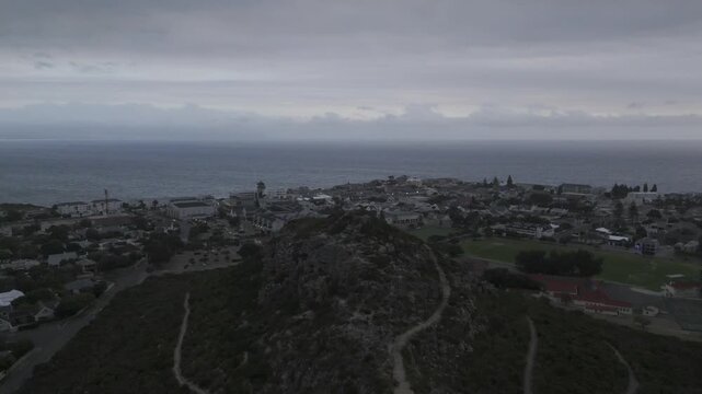 Drone flies south over Hoy's Koppie at sunset in Hermanus on the Garden Route in South Africa