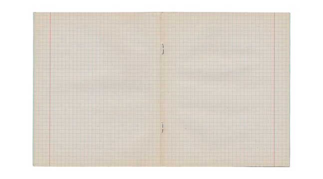 Worn open notebook graph paper spread with torn center and stains
