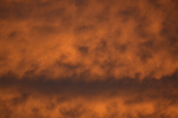 Energetic Diagonal Orange Cloud Bands at Sunset