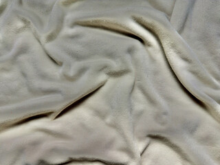 beige velvet fabric texture soft swirling folds subtle sheen serene neutral backdrop for wallpaper or banner design