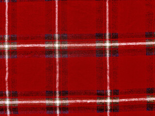 vibrant crimson tartan plaid fabric closeup with intersecting white navy beige stripes evoking cozy scottish heritage for seasonal wallpaper or fashion banner