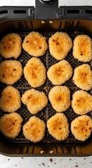 Delicious Crispy Golden Nuggets Glazed with Sauce Cooking Inside Air Fryer Basket
