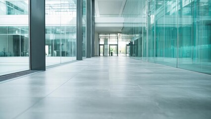 A long, empty glass-walled office hallway with a sleek tiled floor leading to bright doors at the far end. Concept Glass-walled corridor, Sleek tiled floor, Long empty hallway, Bright exit doors