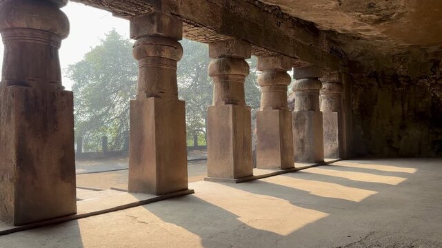 Rock-cut temple colonnade at Elephanta Caves on Elephanta Island, Mumbai Harbor, Maharashtra, India.
