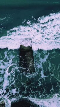 the splash of waves on a breakwater in a storm