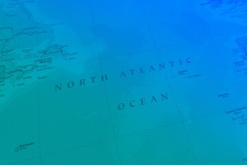 Map of North Atlantic Ocean in green and blue colors. Selective focus on label, close-up view © Halina