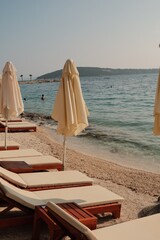 Beach chairs and umbrella on the beach on a sunny day