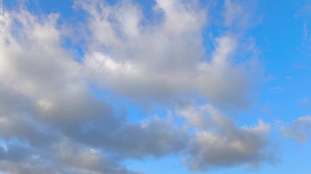 Orange altocumulus and cirrocumulus clouds moving at sunset
