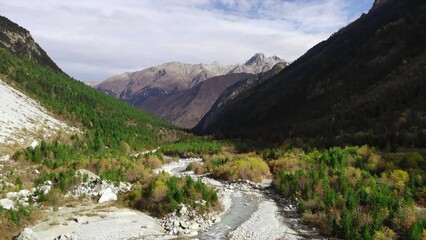 Fototapeta premium Aerial view of mountain valley with river and forest. Media
