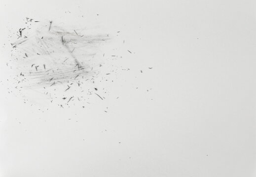 Black eraser scrap, shavings on white paper background, design element, top view