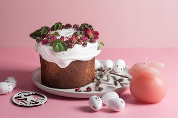 Festive Easter Kulich сake with rose petals and spring decorations