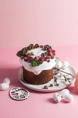 Festive Easter Kulich сake with rose petals and spring decorations