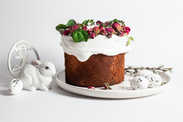 Festive Easter Kulich сake with rose petals and spring decorations