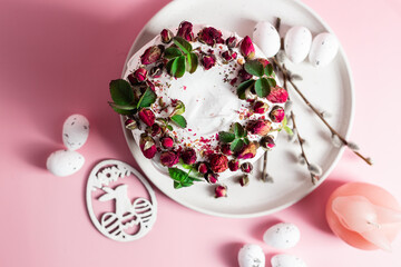 Festive Easter Kulich сake with rose petals and spring decorations