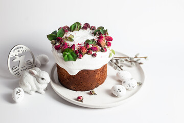 Festive Easter Kulich сake with rose petals and spring decorations